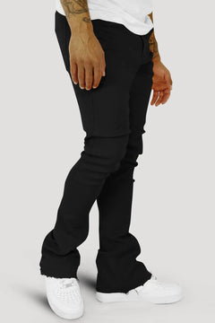 Black stacked jeans for men with a tapered leg and folded stack at the ankle
